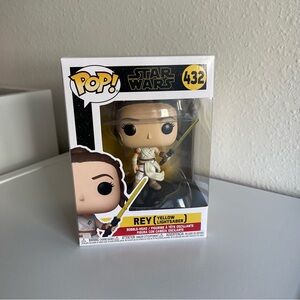 Rey with yellow lightsaber Funko Pop